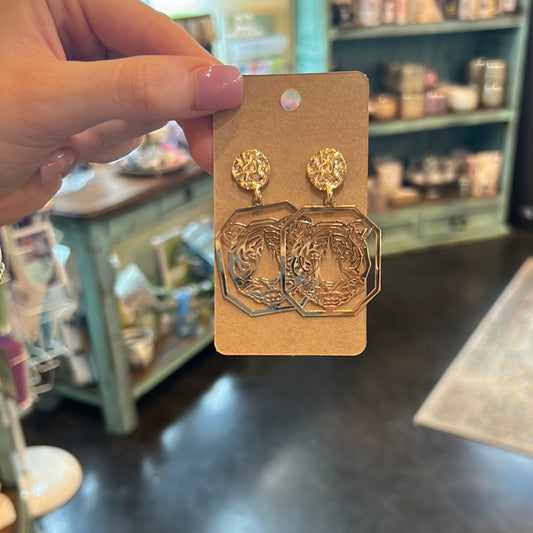 Golden metal earrings featuring a tiger.
