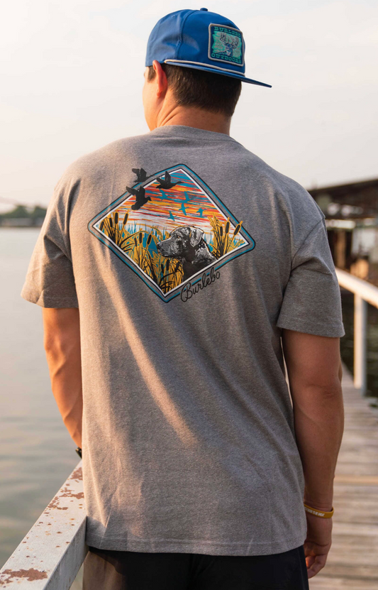 Model featuring men's gray Burlebo t-shirt with a duck hunting scene.