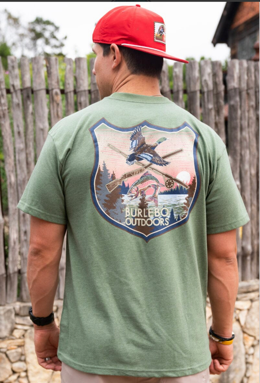 Model featuring men's green Burlebo rob and gun tee with an outdoor scene.